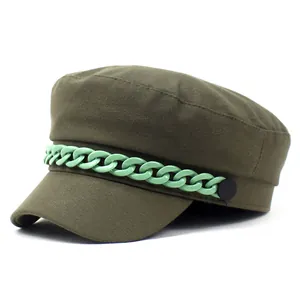 Detail of army green flat top captain hat with light green plastic chain decoration
