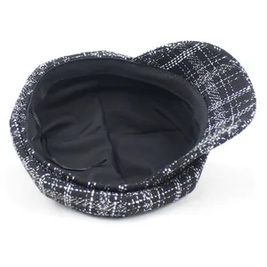 Classic black and white checkered tweed newsboy hat with adjustable inner lining cord
