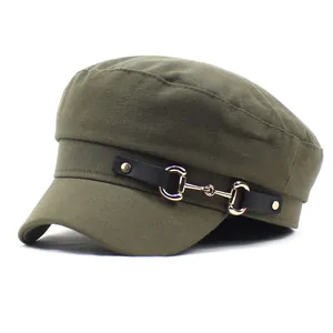Macro detail of military style flat top cap in dark green canvas with metal horsebit
