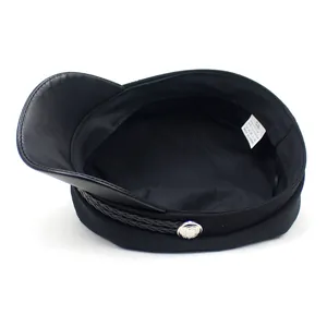Women's black newsboy cap with leather brim and braided cord detail on white background