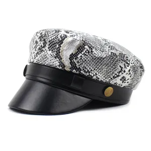 Women's fashion snake pattern newsboy cap with black leather visor and metal button detail