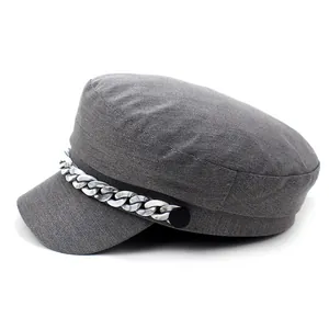Detail of grey cotton flat top navy cap with decorative marble pattern chain and side buttons