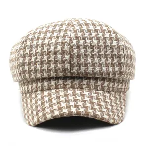 Detailed view of the khaki houndstooth texture on this vintage women's baker boy hat