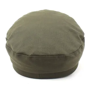 Detail view of the olive green flat top navy cap made of cotton twill fabric
