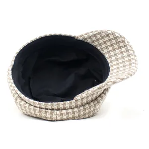 Women's vintage houndstooth newsboy cap in brown and white with warm black lining