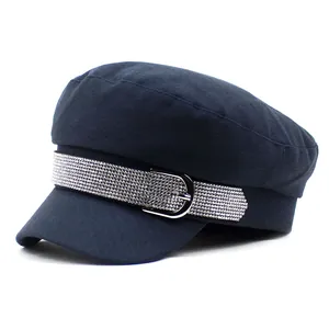 Navy blue newsboy hat with rhinestone belt buckle detail shown from a 45-degree angle