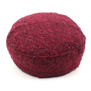 Detail of burgundy tweed fabric with metallic gold thread on the casual flat top cap