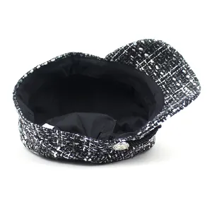 Women's black and white tweed newsboy cap with wool texture and silver metal button detail