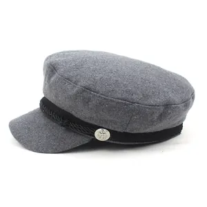 Detail of wool texture on grey newsboy hat with braided cord and anchor button