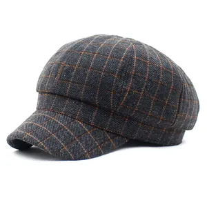 Macro detail of retro grey and orange plaid cotton fabric on the newsboy cap crown