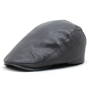 Detail view of stitched dark grey PU leather flat cap showing texture and curved brim