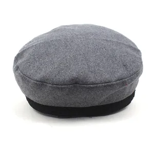 Detail of grey wool felt newsboy hat with black jacquard band decoration
