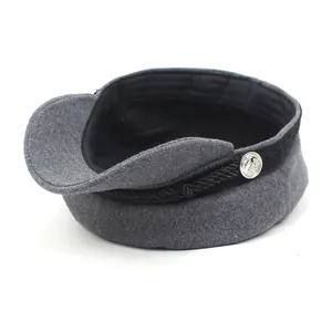 Detailed close-up of a grey wool newsboy cap with black braided rope and silver button