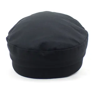 Detail of a black cotton fiddler cap with a flat top and durable structured brim