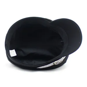 Detail view of black military hat with rhinestone band and metal buckle accent