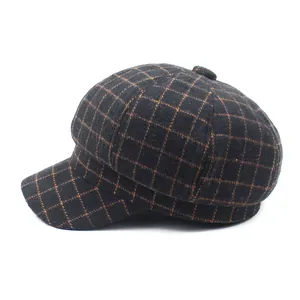 Close-up of vintage plaid patterns and textured wool fabric on this newsboy cap
