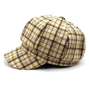 Detailed view of the plaid pattern and texture on a British style newsboy hat