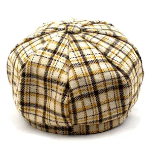 Detail of yellow and black plaid newsboy cap with vintage octagonal patchwork texture