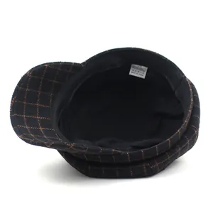 Plaid octagonal beret cap with cotton lining and size label shown from inside view
