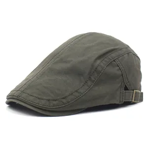 Gros plan sur la boucle métallique ajustable d'une casquette plate en coton olive