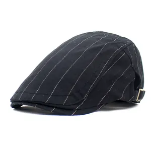 Detail view of black cotton flat cap with gold stripes and silver metal buckle