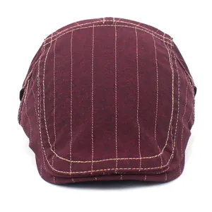Close-up of burgundy cotton flat cap showing vertical stripes and decorative stitching