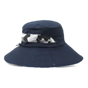 Detail of navy blue outdoor bucket hat with adjustable toggle and camo webbing trim