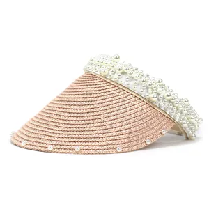 Close-up of pink straw sun hat showing intricate woven texture and pearl embellishments