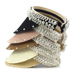 Detail of straw sun visors with pearl trim and headband design in multiple colors