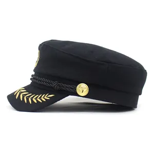 Detail of military cap with gold wheat embroidery and metallic anchor button accents