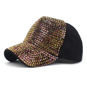 Detailed view of shimmering gold rhinestones on black canvas baseball cap visor