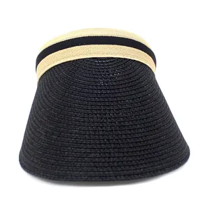 Close-up of woven paper straw texture and elastic striped headband on black sun visor hat