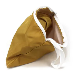 Detail of a ginger yellow waterproof sun hat storage bag with zipper and handle