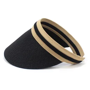 Detail of fine woven texture and black brim contrast on summer straw sun visor hat