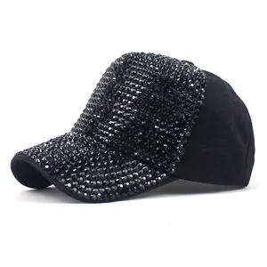 Close-up of black baseball cap featuring intricate black rhinestones and stud details