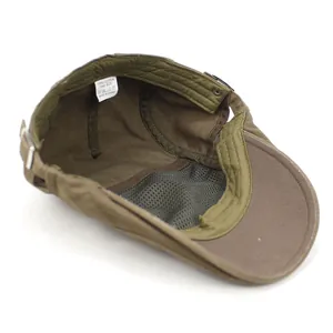 Detail view of cotton flat cap with gray mesh lining and adjustable metal buckle