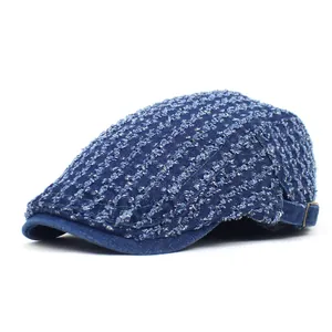 Distressed dark blue denim beret cap with retro textured pattern and adjustable metal buckle