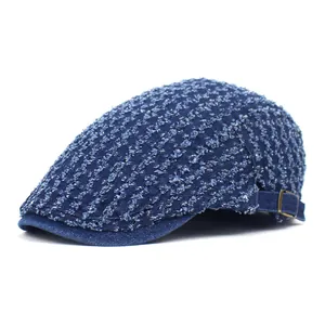 Distressed blue denim flat cap with vintage frayed texture and adjustable metal side buckle