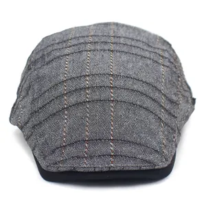 Detailed view of dark grey striped ivy cap fabric with black trim on the peak edge