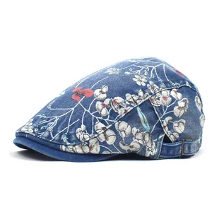 Blue washed denim flat cap with floral print and adjustable metal side buckle