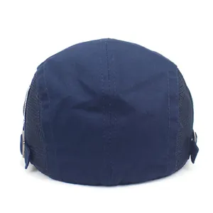 Detail view of the breathable mesh splicing and adjustable metal buckle on blue beret
