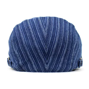 Rear view of striped cotton denim newsboy cap featuring adjustable metal side buckles