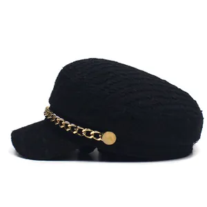 Fashionable black tweed newsboy cap with a vintage gold chain detail and side buttons