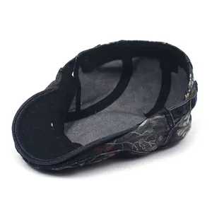 Macro detail of 100% cotton inner lining and floral denim pattern of the beret cap