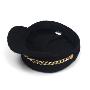 Detail view of the black tweed newsboy hat inner lining with polyester wash label