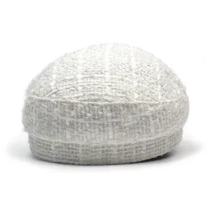 Detailed close-up of white tweed nautical hat with rich woven texture and fabric detail