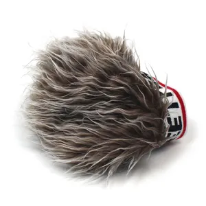 Detail of grey-brown faux fur wig cap with a tricolor striped elastic letter band