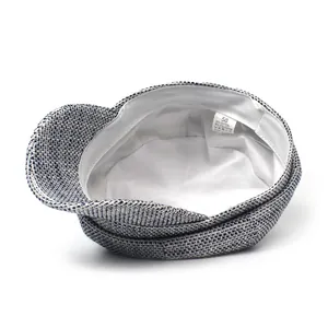 Detail view of newsboy cap interior showing white lining and size 58 washing label