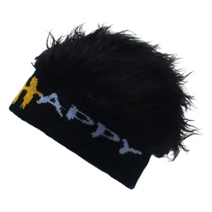 Detail of knitted beanie featuring HAPPY text and fluffy black faux hair texture