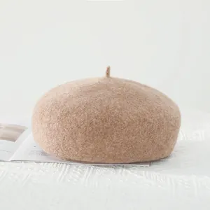 Close-up of wool beret showing thick fuzzy texture and top detail in camel color